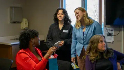 Photo of three women speaking.